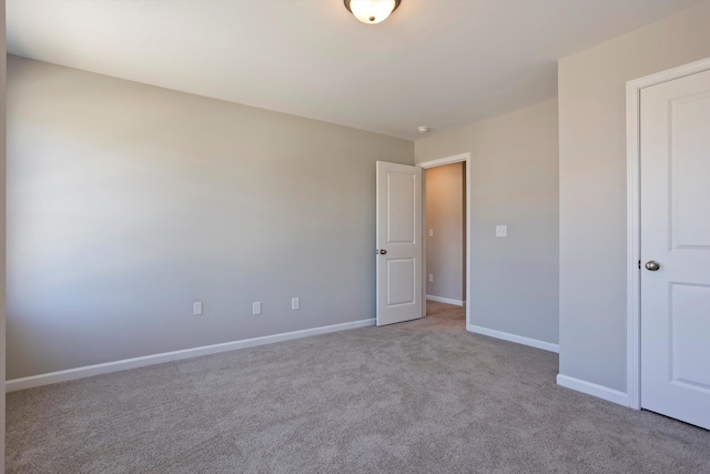 unfurnished bedroom with carpet floors and baseboards