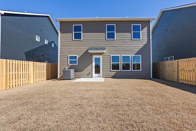 back of property featuring a yard, cooling unit, a fenced backyard, and a patio