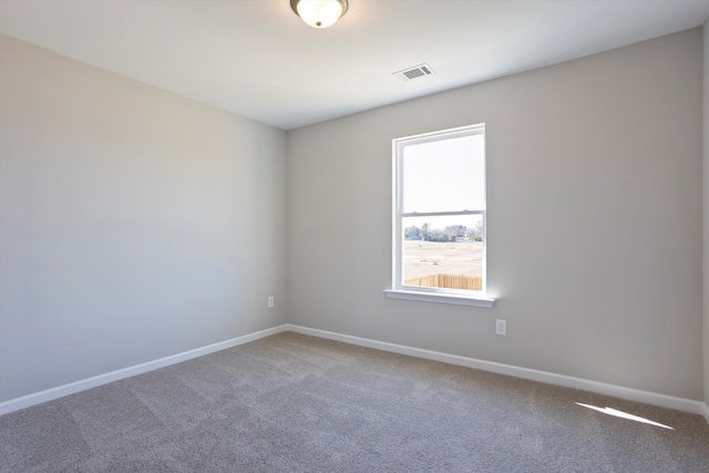 carpeted spare room with baseboards and visible vents