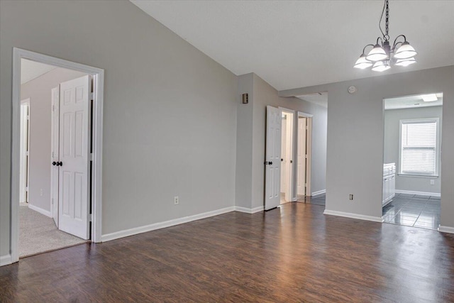 4005 Calypso Dr, Augusta, GA 30909 - spare room with dark wood finished floors, lofted ceiling, a chandelier, and a smoke detector