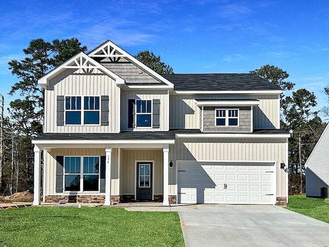 craftsman inspired home with a front yard and a garage