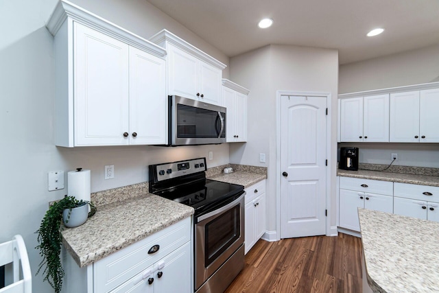 kitchen with dark hardwood / wood-style floors, white cabinetry, and stainless steel appliances