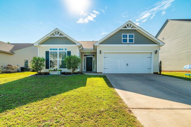 craftsman house with a garage, central air condition unit, and a front lawn