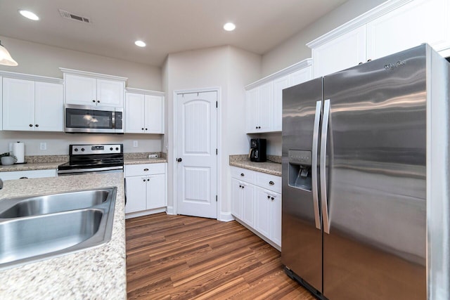 kitchen featuring white cabinetry, sink, dark hardwood / wood-style floors, and appliances with stainless steel finishes