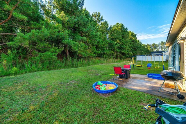 view of yard with a playground and a patio area