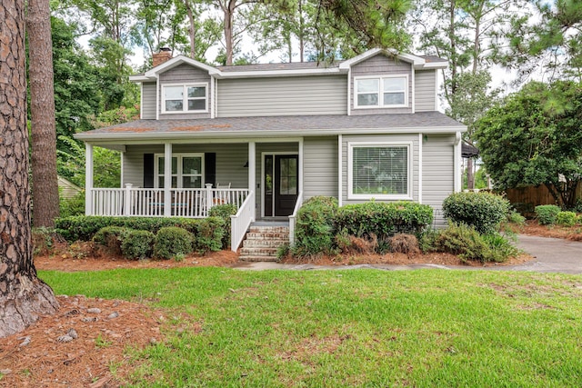 view of front of home with a front yard and a porch