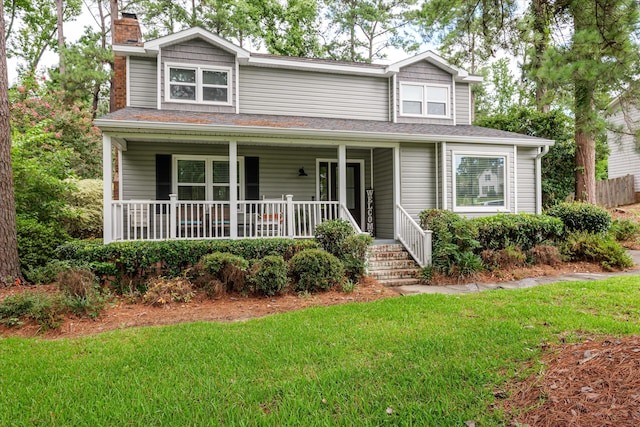 view of front of home with a porch and a front lawn