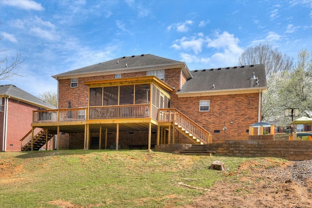 back of house with a sunroom, a shingled roof, stairs, a lawn, and brick siding