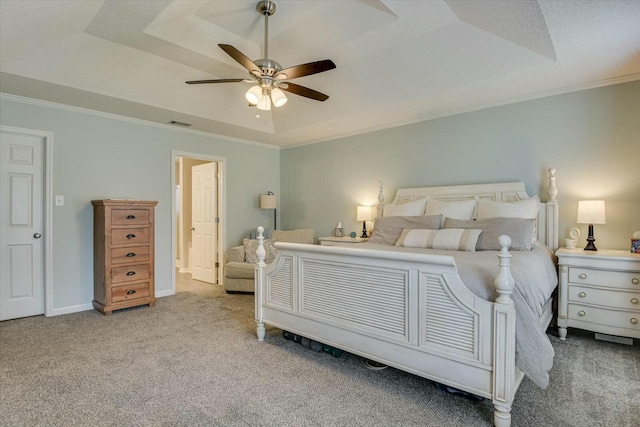 carpeted bedroom featuring visible vents, a raised ceiling, baseboards, and ornamental molding