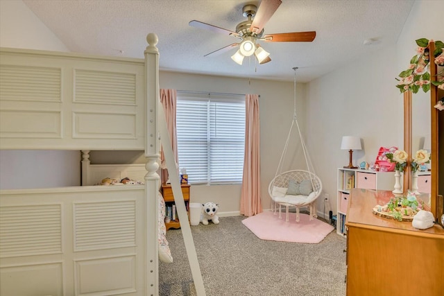 bedroom featuring carpet flooring, a ceiling fan, baseboards, and a textured ceiling