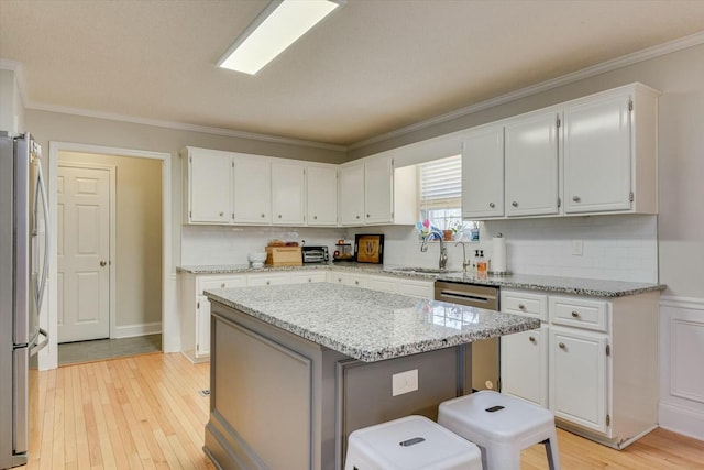 kitchen featuring white cabinets, appliances with stainless steel finishes, and a sink