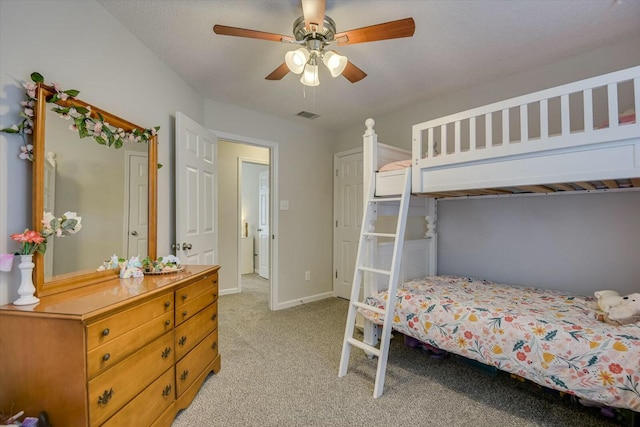 bedroom with ceiling fan, light colored carpet, visible vents, and baseboards