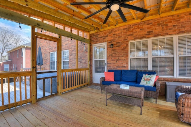 wooden deck featuring an outdoor hangout area and a ceiling fan