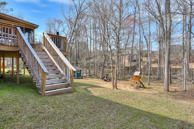 view of yard featuring stairway, a wooden deck, and a playground