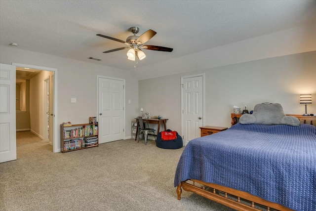 bedroom featuring a ceiling fan, baseboards, carpet, visible vents, and a textured ceiling