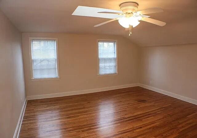 bonus room featuring dark hardwood / wood-style flooring, ceiling fan, and lofted ceiling