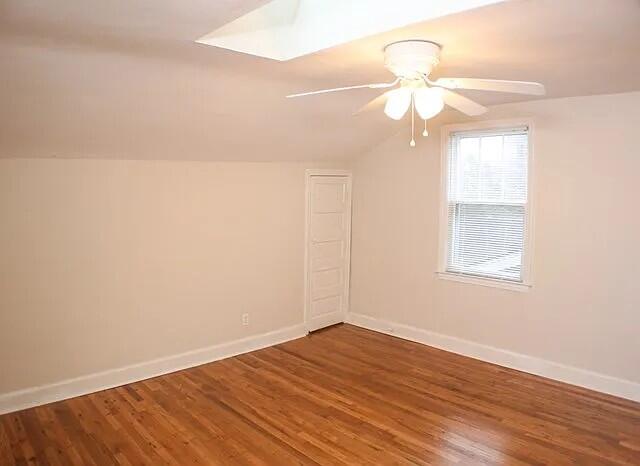 additional living space featuring hardwood / wood-style floors, ceiling fan, and lofted ceiling