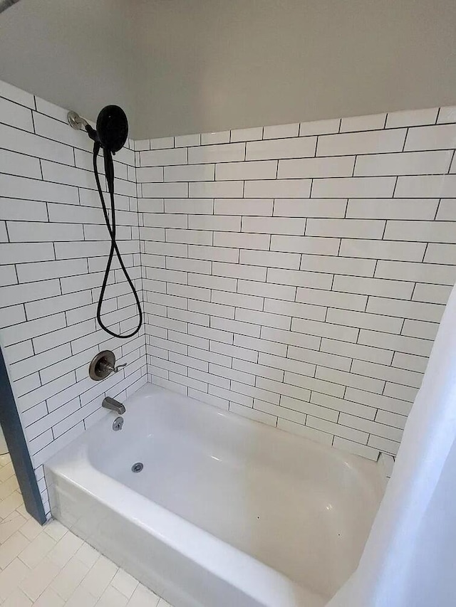 bathroom featuring tile patterned floors and tiled shower / bath combo