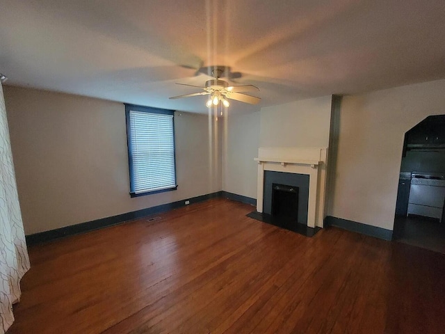 unfurnished living room featuring dark hardwood / wood-style floors and ceiling fan