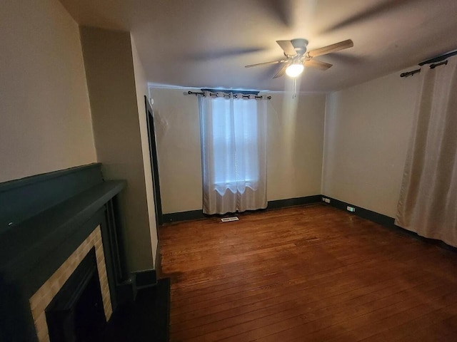 empty room featuring hardwood / wood-style floors and ceiling fan