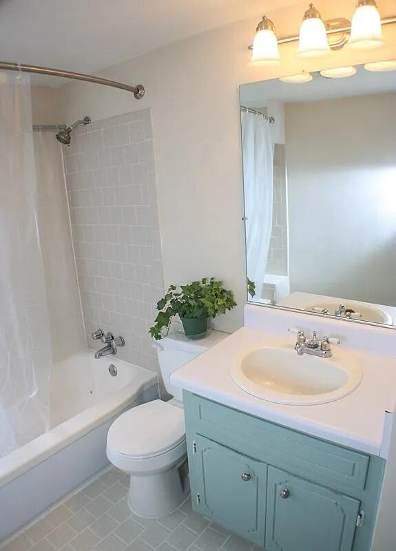 full bathroom with tile patterned flooring, vanity, toilet, and shower / tub combo with curtain