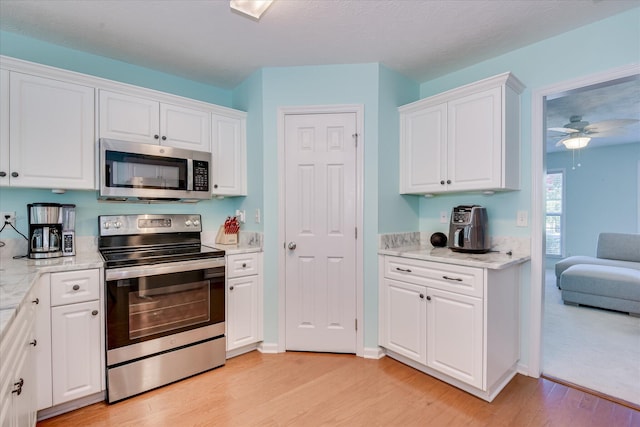 109 Mitchell Dr, North Augusta, SC 29860 - kitchen with stainless steel appliances, light wood finished floors, white cabinetry, and ceiling fan