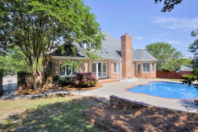 view of pool featuring french doors and a patio
