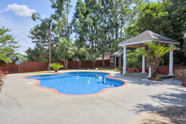 view of pool featuring a fenced backyard, a patio, a gazebo, and an outdoor structure