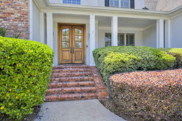 view of exterior entry featuring stucco siding