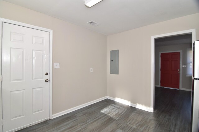 spare room with electric panel and dark wood-type flooring