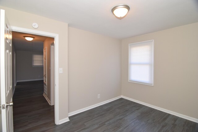 unfurnished room featuring dark hardwood / wood-style floors