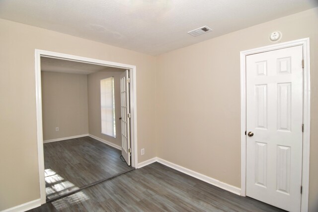 unfurnished room with dark hardwood / wood-style floors