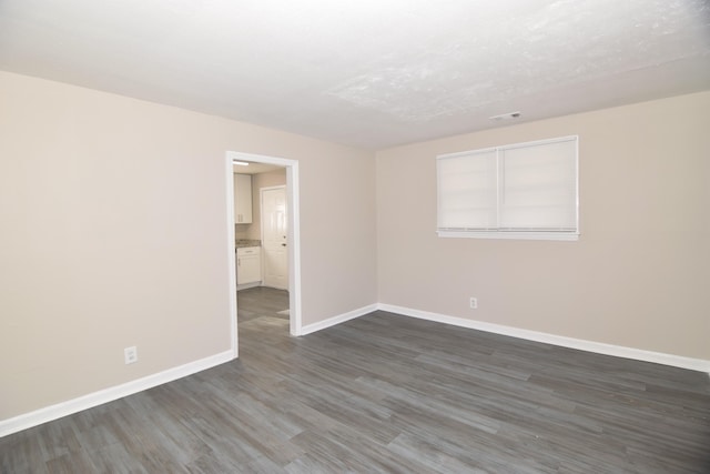 spare room with dark hardwood / wood-style flooring