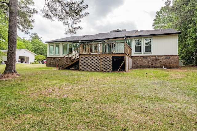 rear view of house featuring a sunroom, a wooden deck, and a lawn