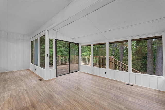 unfurnished sunroom featuring lofted ceiling