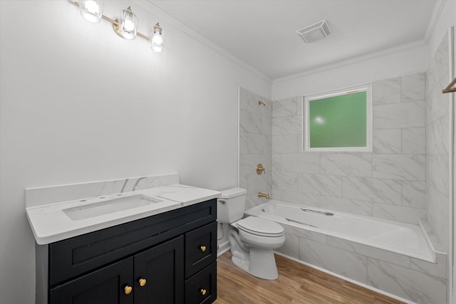 full bathroom featuring vanity, ornamental molding, tiled shower / bath combo, and hardwood / wood-style flooring