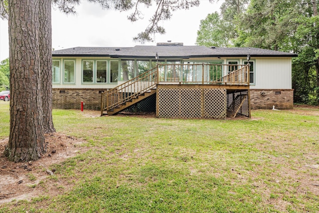 back of house with a deck and a yard