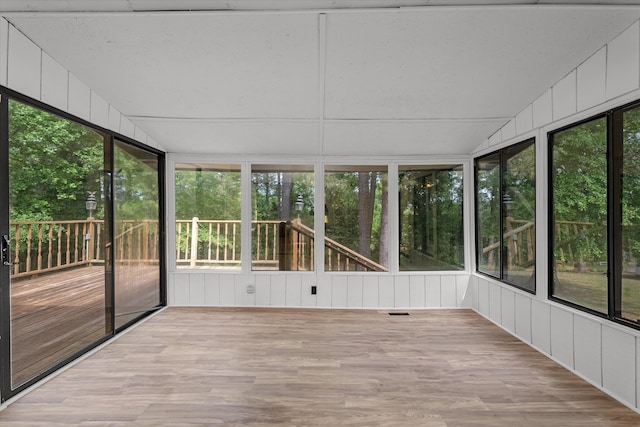 unfurnished sunroom with plenty of natural light and lofted ceiling