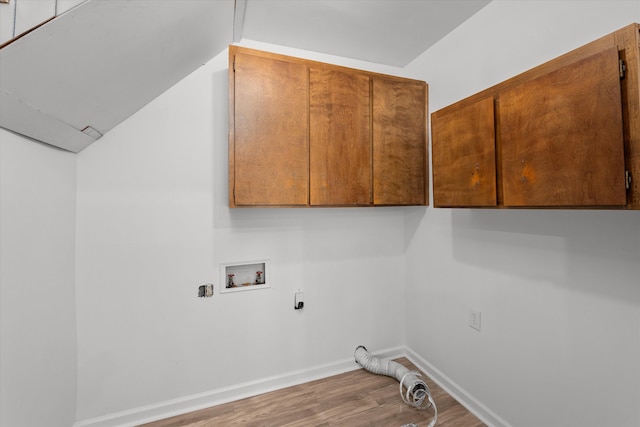 clothes washing area featuring cabinets, washer hookup, hookup for an electric dryer, and hardwood / wood-style floors