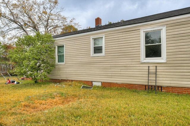 view of property exterior with a yard