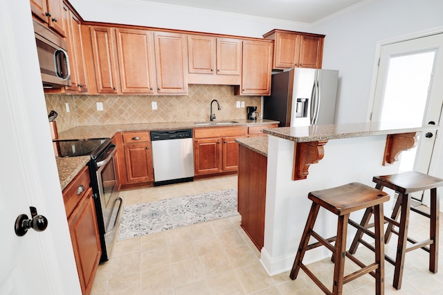 5553 Connor Dr, Evans, GA 30809 - kitchen featuring stainless steel appliances, decorative backsplash, a breakfast bar area, ornamental molding, and light tile patterned floors