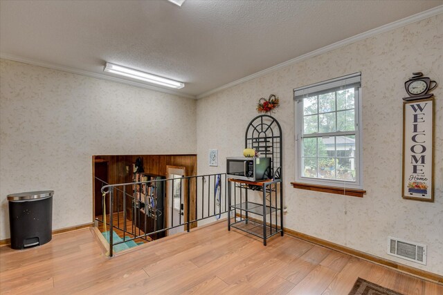 4056 Burning Tree Ln, Augusta, GA 30906 - corridor featuring wood finished floors, an upstairs landing, crown molding, a textured ceiling, and wallpapered walls