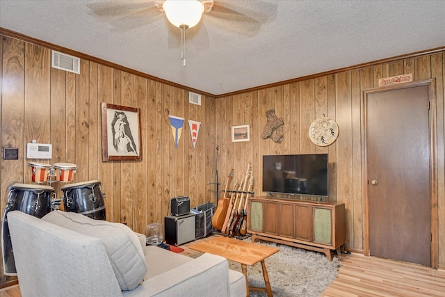 4056 Burning Tree Ln, Augusta, GA 30906 - living area with ornamental molding, wood finished floors, ceiling fan, a textured ceiling, and wood walls
