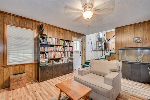 4056 Burning Tree Ln, Augusta, GA 30906 - living area with wood walls, a textured ceiling, wood finished floors, stairs, and ceiling fan