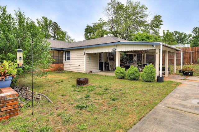 4056 Burning Tree Ln, Augusta, GA 30906 - back of house featuring an outdoor fire pit and roof with shingles