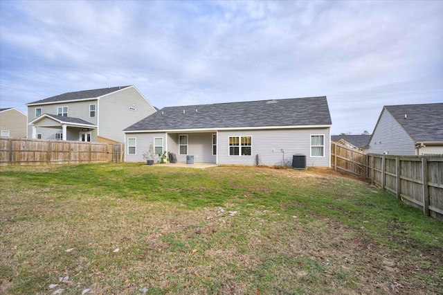 back of house with a lawn and central air condition unit