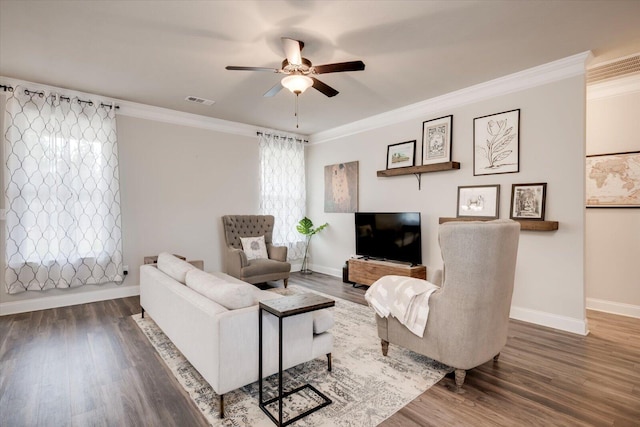 living room featuring dark hardwood / wood-style flooring, ceiling fan, and crown molding