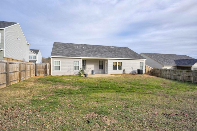 back of house featuring central AC unit, a patio area, and a lawn