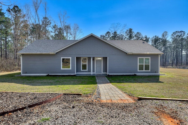 view of front facade with a front lawn and roof with shingles