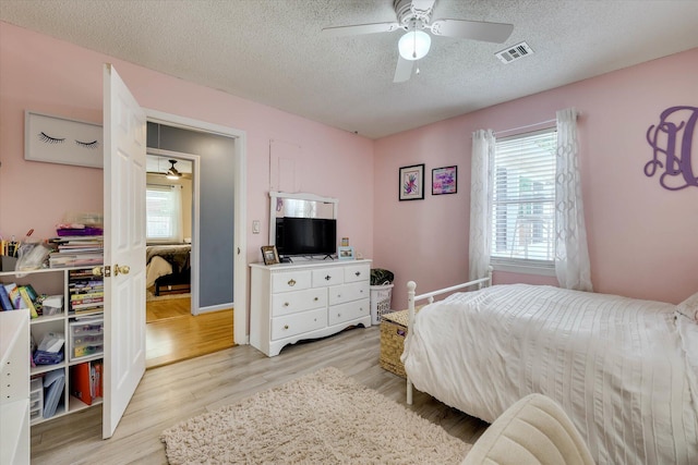 120 Stone St, Harlem, GA 30814 - bedroom featuring a textured ceiling, light wood-style floors, and a ceiling fan